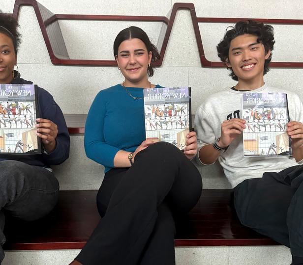 Three students sitting on the large steps at Juilliard's front entrance each hold a copy of 'The New Yorker' magazine. The magazine cover features an illustration of a dance studio with large windows, showcasing people engaged in music and dance. The students smile and they all seem proud to be displaying the magazine.